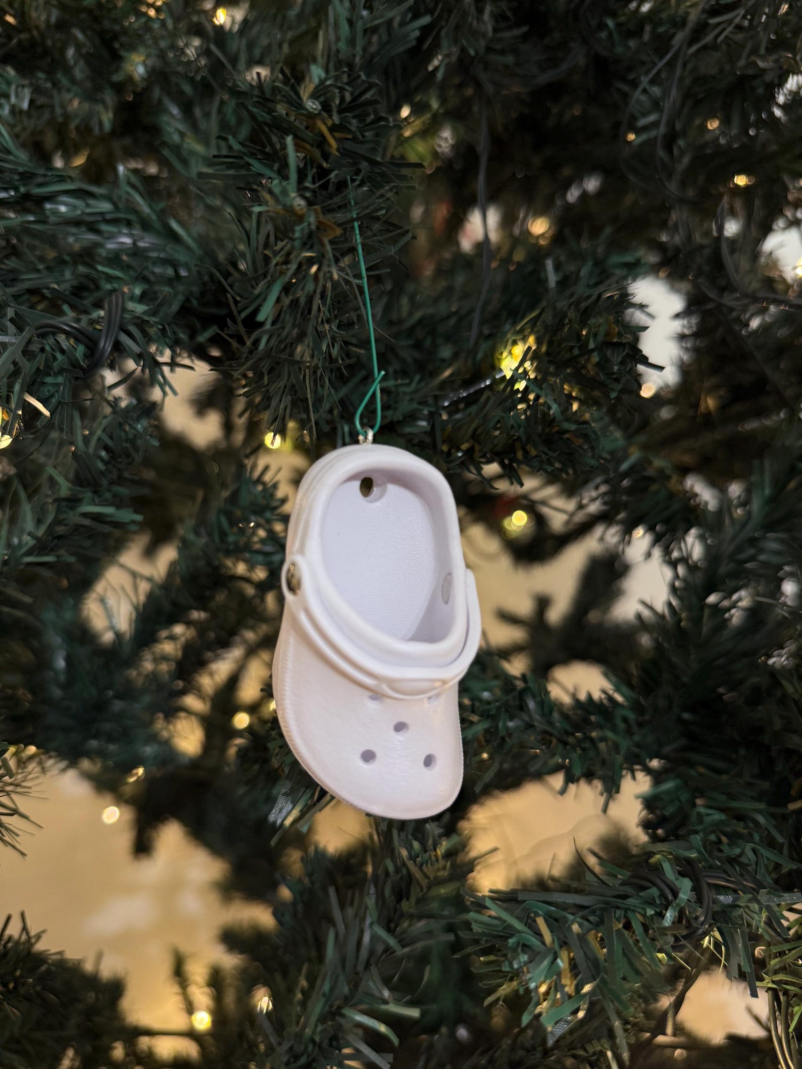 Mini colorful Croc Christmas ornament hanging on tree