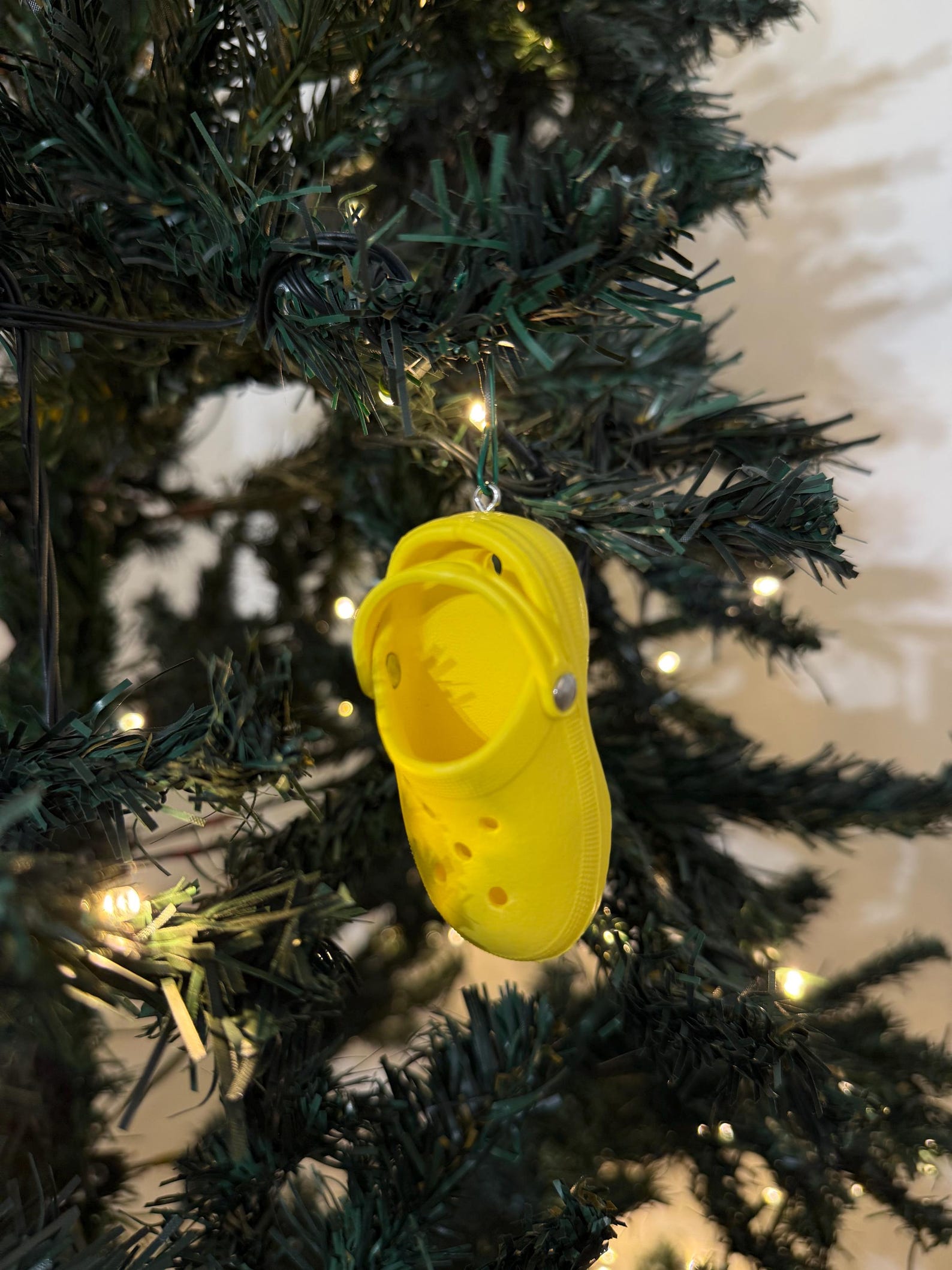 Mini colorful Croc Christmas ornament hanging on tree