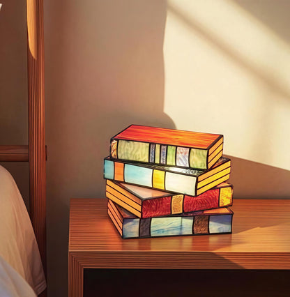 stained glass book lamp set glowing on nightstand for book lovers