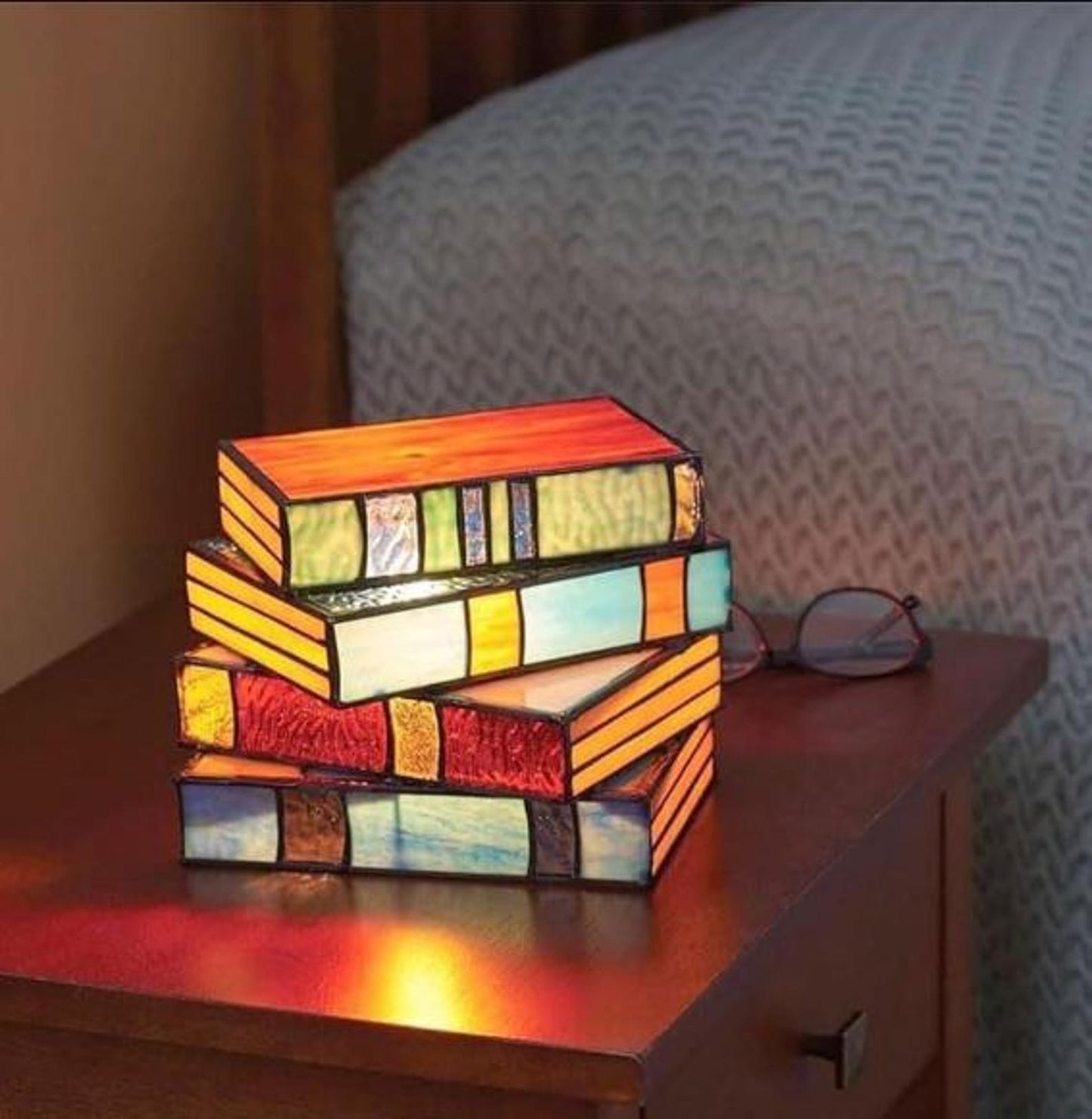 stained glass book lamp set glowing on nightstand for book lovers